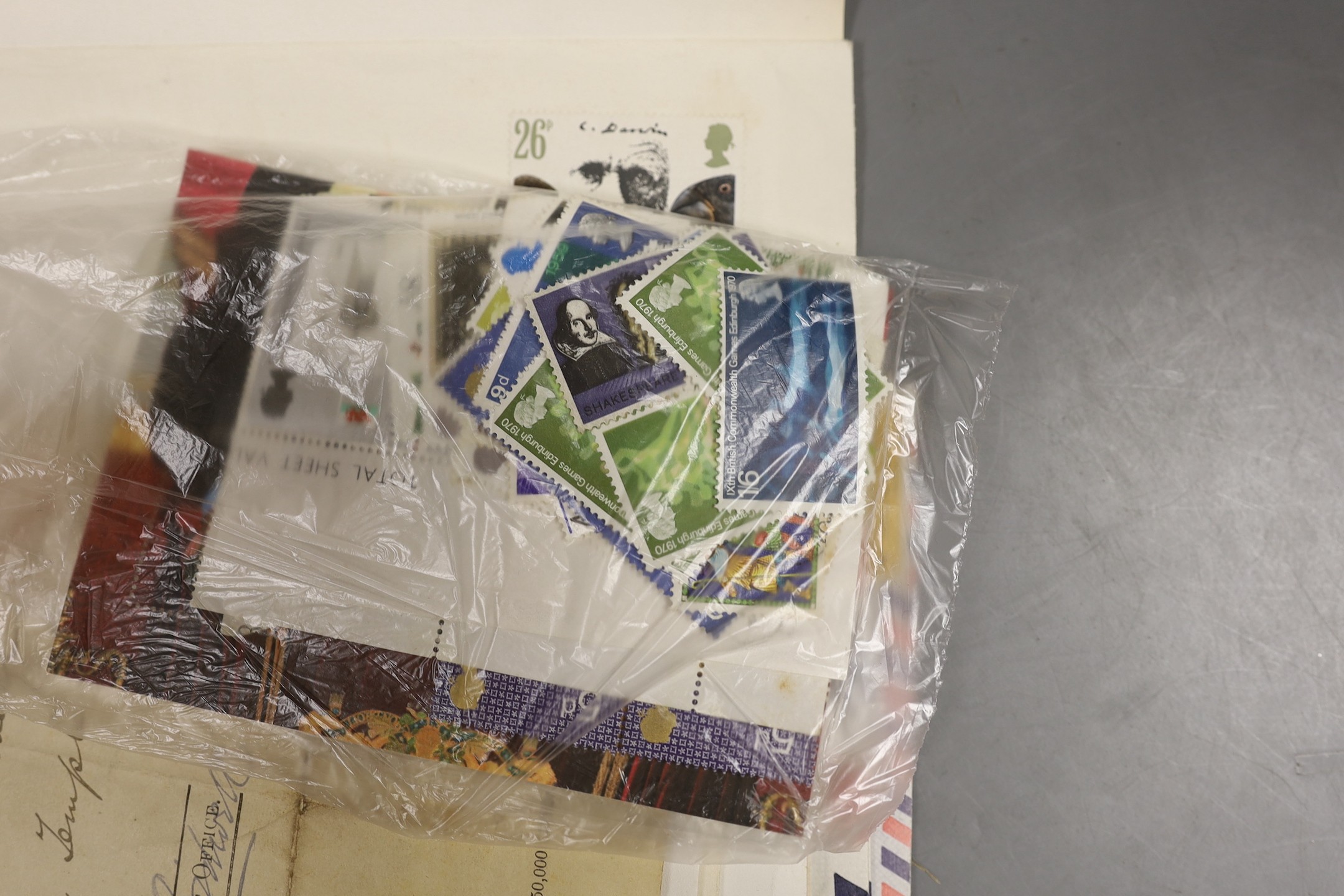 A stamp album of world stamps and a collection of loose stamps.